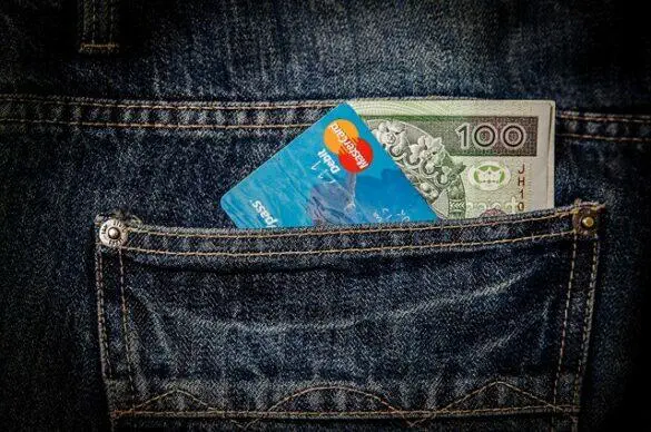 Credit card and 100 Polish Zloty in a jeans pocket.