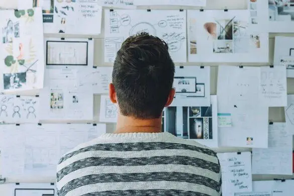 Man reviewing project plans on a wall