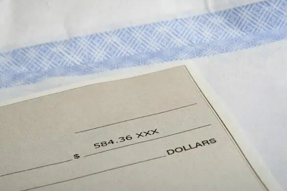 Check with 4.36 written amount, ready to be filled out.